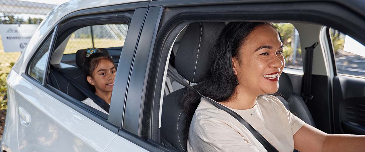 A woman driving with a child in the car