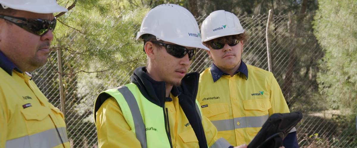 Workers in high vis jackets with Transurban and Ventia labels 